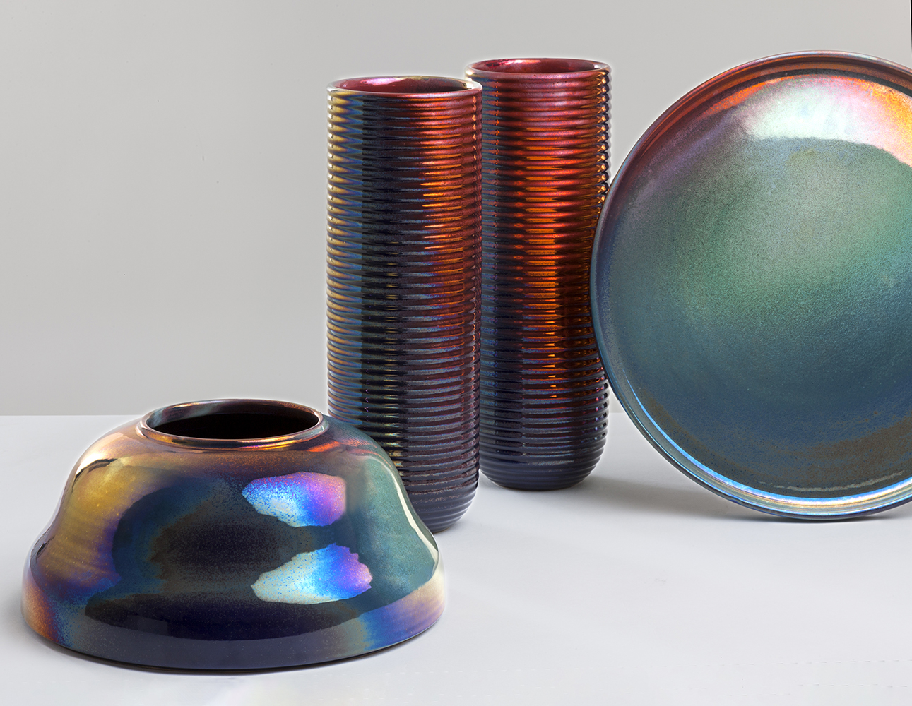 Image of metallic colored food and beverage tins in different shapes.