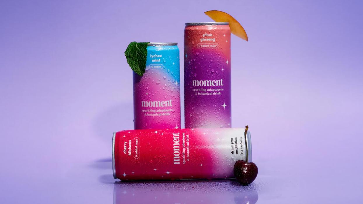A marketing photo of 3 "Moment" branded aluminum cans.