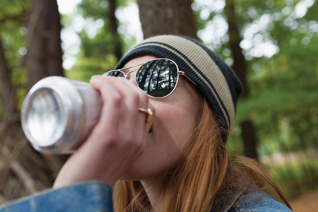 Woman Enjoying a Beverage Outdoors