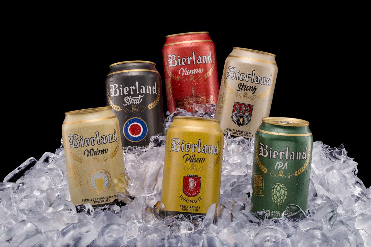 Six different colored metal beer cans siting on a mound of ice