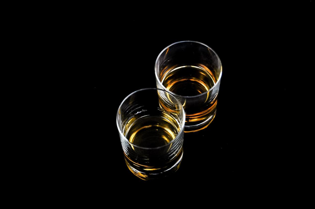 Two classes of scotch with a black background.