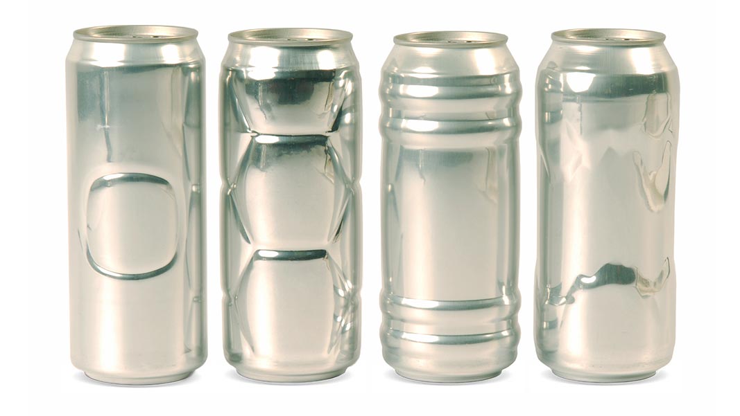 shaped-can-2x.jpeg Four cans standing upright that have different cuttings and curves on each can.