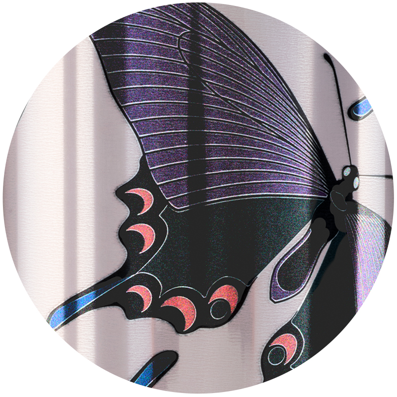 sparkle-2x.jpeg Detail of sparkle can showing a purple and black butterfly wing with pink and blue details.