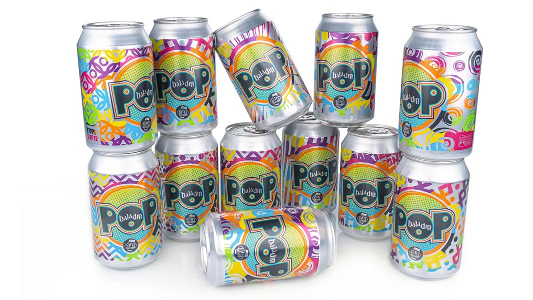 variable-baladin-pop.jpeg Multiple cans stacked in a group with multicolored printed soda can designs