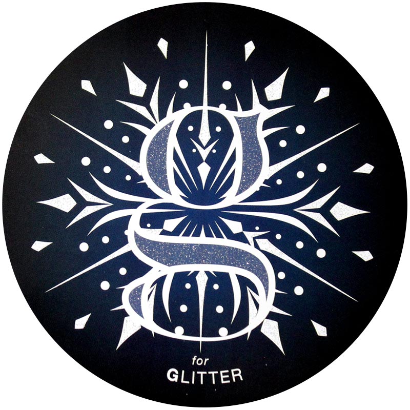 Glitter-2x.jpeg A glitter finish with a lowercase "g" and a intricate snowflake design behind the G.