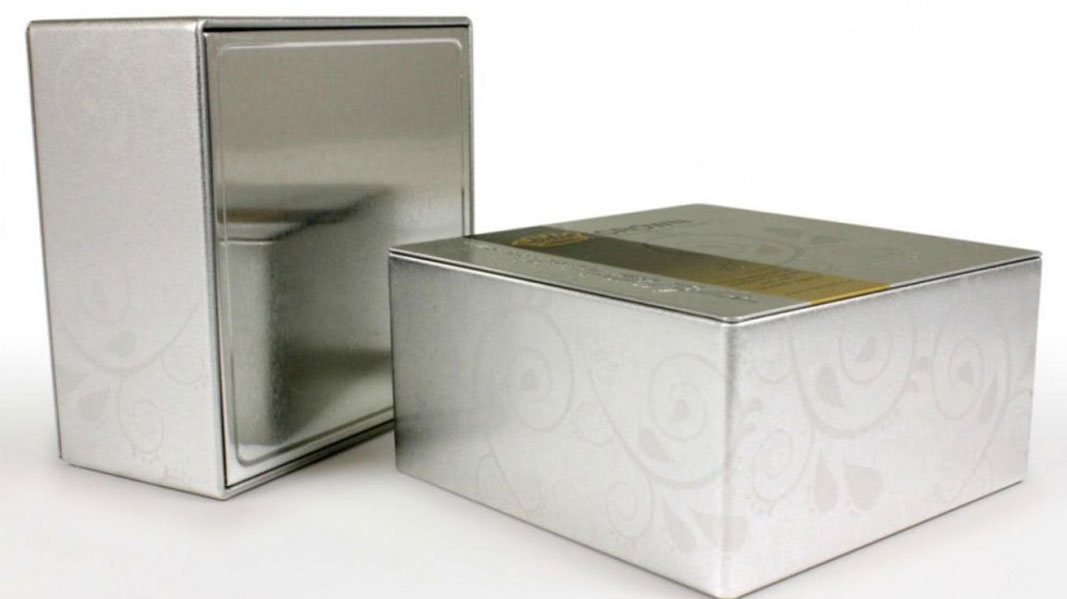 SeatedEnd.jpeg Two tins with fancy engravings on them