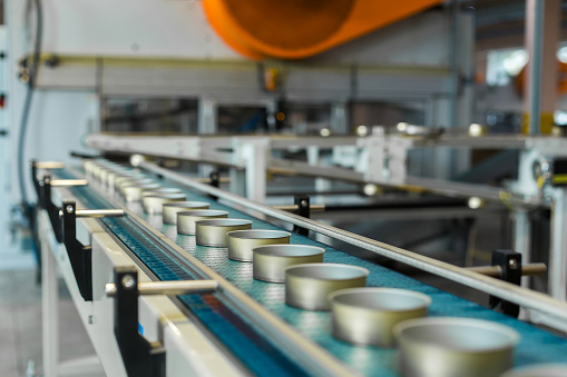 food cans on a conveyor belt