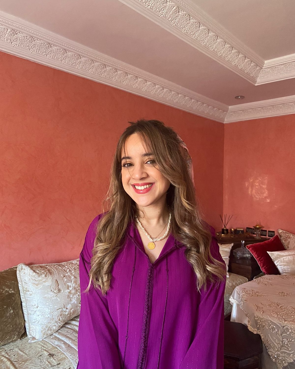 picture of young girl in living room setting with purple shirt and long brown girl