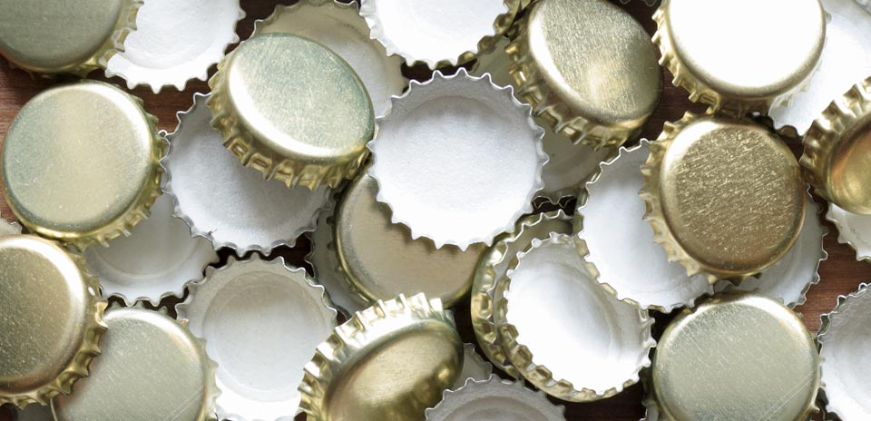 A pile of bottle caps with gold outside and white inside