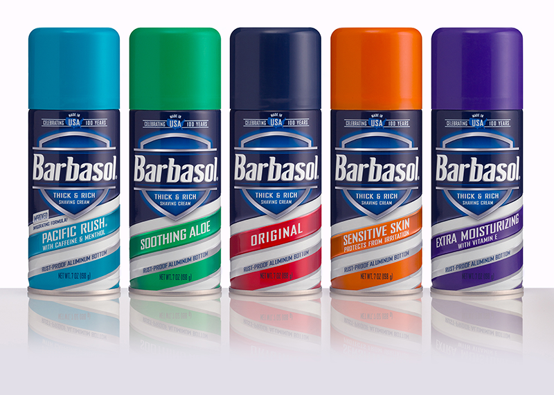 5 cans of shaving cream with multi-colored tops lined up next to one another.
