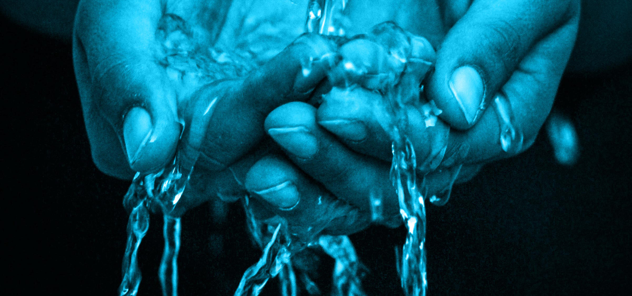 hands under water with a blue tint