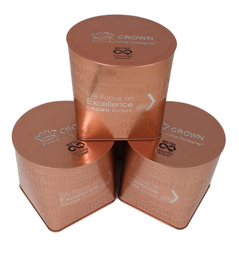 Three bronze tins stacked on top of one another.