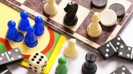 A collection of different board game pieces sitting on a chess board.