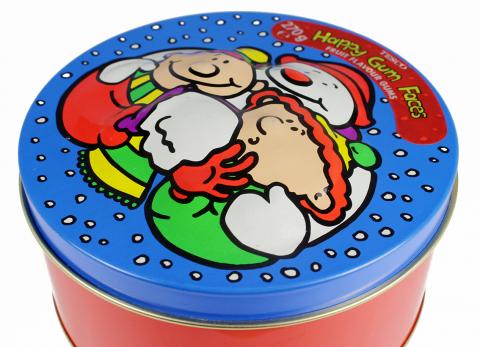 A winter holiday themed cookie tin with a bulge emboss applied to the middle of the lid.