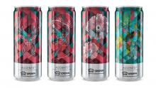 Four cans standing upright with different colors and images printed on them 